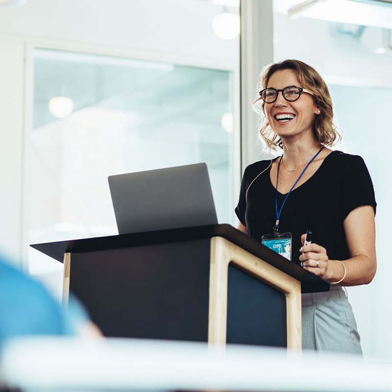 Woman presenting at a conference