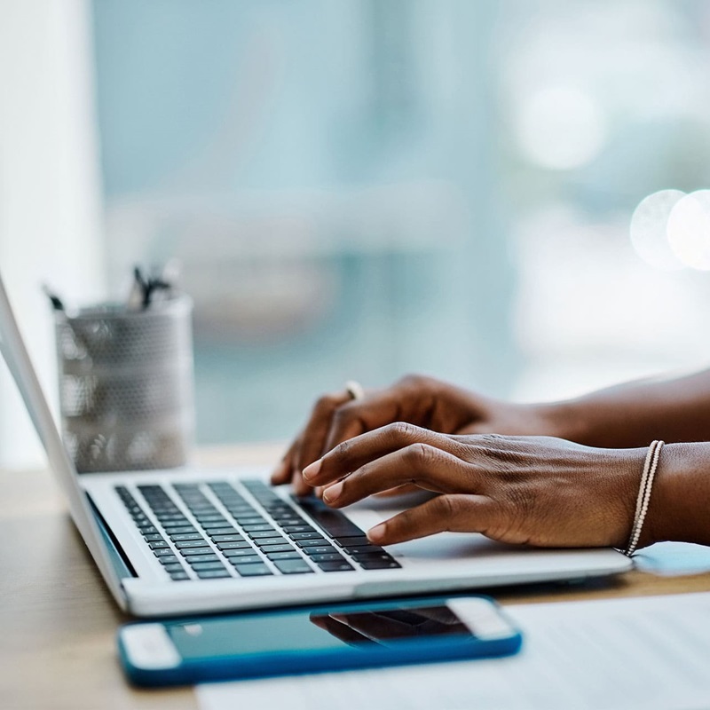 Law clerk typing on a laptop