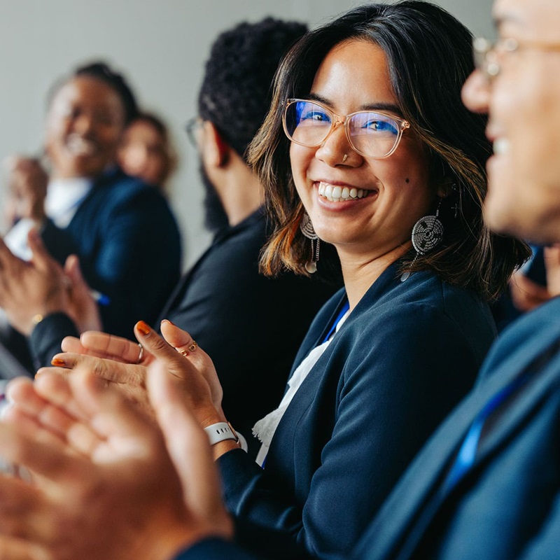 Law clerk smiling and clapping after presentation
